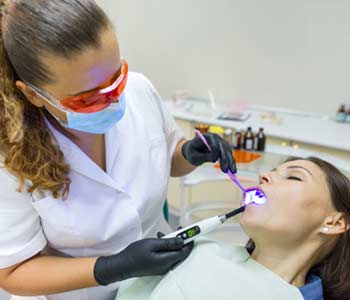 Dentist doing a dental tratment for a lady patient by using sedation treatment